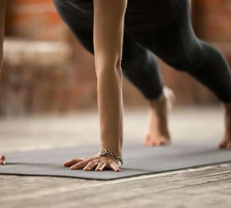 woman performing a mat pilates exercise