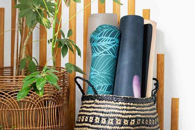 Rolled up yoga mats in a basket